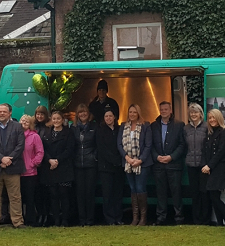 Members of the A.Proctor Group team gather outside their UK tour van